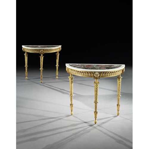 A pair of demi-lune giltwood side tables